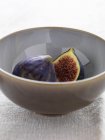 Halved fig in bowl, close up shot — Stock Photo