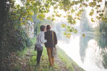 Young couple by riverbank, Dolo, Venice, Italy — Stock Photo