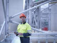 Portrait of worker holding digital tablet at biomass facility — Stock Photo