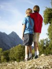 Rear view of two brothers gazing at mountains, Majorca, Spain — Stock Photo