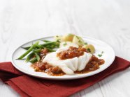 Cod fillet in tomato sauce with green beans and new potatoes — Stock Photo