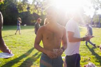 Adults friends at sunset party in park — Stock Photo