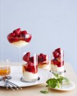 Drinking glasses filled with champagne strawberry desserts — Stock Photo