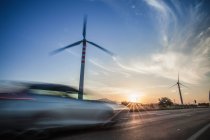Car speeding past wind turbines, Cagliari, Sardinia, Italy — Stock Photo