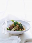 Beef noodles bowl with chopsticks — Stock Photo