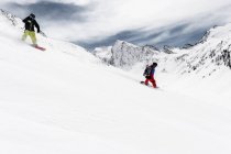 Two men snowboarding downhill, Obergurgl, Austria — Stock Photo