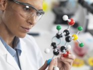 Scientist viewing a molecular structure in a laboratory — Stock Photo