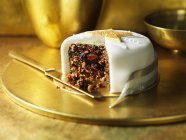 Iced traditional fruit christmas cake with knife — Stock Photo