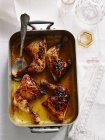 Roast chicken pieces in baking tin, top view — Stock Photo