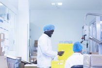 Arbeiter verpacken pharmazeutische Produkte in pharmazeutischen Anlagen — Stockfoto