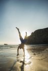 Teenage boy doing handstand at beach, Camaret-sur-mer, Brittany, France — Stock Photo