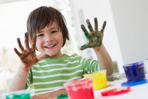 Sorridente ragazzo dito pittura al chiuso — Foto stock