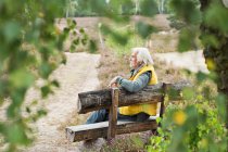 Senior man sitting on bench — Stock Photo