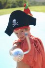 Портрет хлопчика в капелюсі піратів, що вказує на іграшковий меч — стокове фото