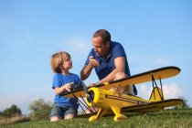 Father and son preparing model plane — Stock Photo