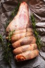 Uncooked leg of lamb with rosemary — Stock Photo