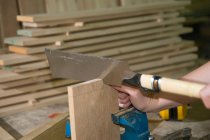 Female carpenter using ryoba (double blade) dozuki (japanese backsaw) to create joint — Stock Photo