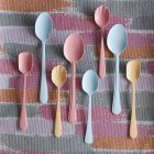 Spoons in different sizes and colours, top view — Stock Photo