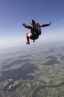Female skydiver free falling over Grenchen, Berne, Switzerland — Stock Photo