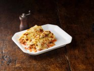 Beef Cannelloni on white rectangular plate — Stock Photo