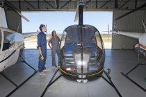 Student pilots checking exterior of helicopter — Stock Photo