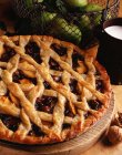 Apple and walnut lattice pie on wooden board — Stock Photo