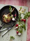 Top view of pan with steak and radishes on table — Stock Photo
