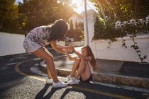 Teenage girls having fun in residential street, Cape Town, South Africa — Stock Photo