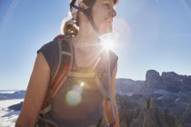 Female hiker hiking in sunlit Dolomites, Sexten, South Tyrol, Italy — Stock Photo