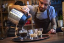 Barista making coffee in coffee shop — Stock Photo