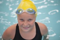 Portrait of schoolgirl swimmer in pool — Stock Photo