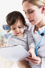 Paediatrician doing assessment of baby boy — Stock Photo