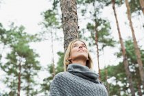 Mid adult woman in forest, low angle — Stock Photo
