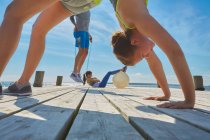 Friends on pier using exercise equipment — Stock Photo