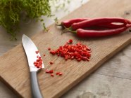 Knife with chopped chili pepper — Stock Photo