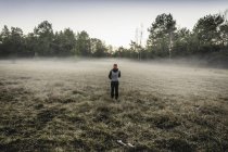 Person on misty open field, Augsburg, Bavaria, Germany — Stock Photo