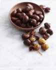 Top view of bowl of fresh chestnuts on marble table — Stock Photo