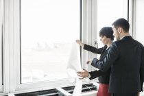 Businesspeople looking at blueprint — Stock Photo