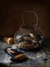 Closeup shot of pile of mussels in basket — Stock Photo