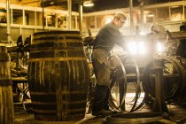 Male cooper making whisky casks in cooperage — Stock Photo