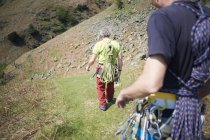 Rock climbers walking on hillside — Stock Photo