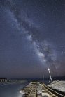 Milky way, starry sky above railway track — Stock Photo
