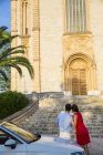 Rear view of young couple with convertible looking at map, Calvia, Majorca, Spain — Stock Photo