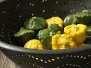 Fresh picked squash vegetables in metal colander — Stock Photo