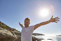 Portrait of mature man on beach, arms outstretched, Cape Town, South Africa — Stock Photo