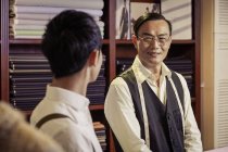 Father and son in family tailors shop — Stock Photo