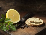 Oat biscuits, peppercorns, half a lemon and coriander — Stock Photo