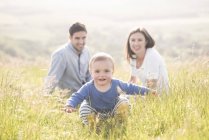 Portrait of young family in field — Stock Photo