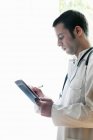 Portrait of doctor using digital tablet — Stock Photo