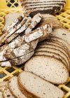 Різноманітність свіжого запеченого нарізаного хліба на ящику — стокове фото